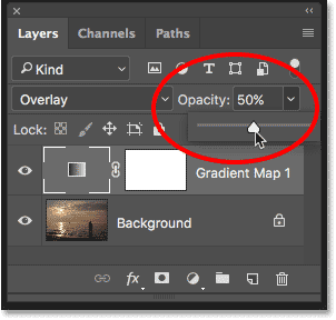 Lowering the opacity of the adjustment layer. 